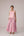 Soft pink sleeveless relaxed fit blouse with pleat details and hand embroidery paired with flared tiered patchwork maxi skirt