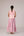 Soft pink sleeveless relaxed fit blouse with pleat details and hand embroidery paired with flared tiered patchwork maxi skirt