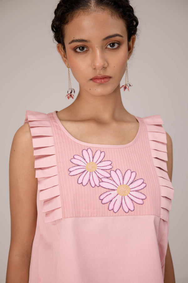 Soft pink sleeveless relaxed fit blouse with pleat details and hand embroidery paired with flared tiered patchwork maxi skirt