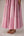 Soft pink sleeveless relaxed fit blouse with pleat details and hand embroidery paired with flared tiered patchwork maxi skirt