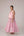 Soft pink sleeveless relaxed fit blouse with pleat details and hand embroidery paired with flared tiered patchwork maxi skirt