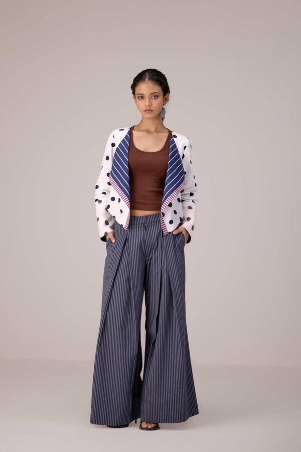 Soft pink sleeveless relaxed fit blouse with pleat details and hand embroidery paired with flared tiered patchwork maxi skirt
