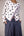 Reversable wrapped jacket in cotton linen paired with pleated striped pants in cotton