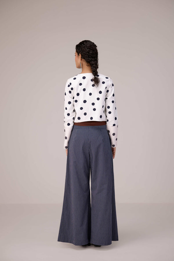 Reversable wrapped jacket in cotton linen paired with pleated striped pants in cotton