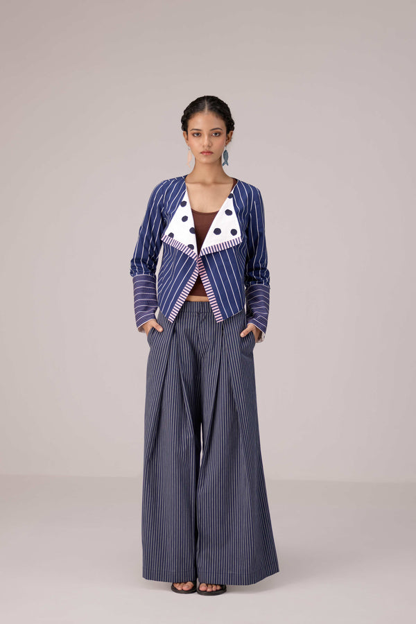 Reversable wrapped jacket in cotton linen paired with pleated striped pants in cotton