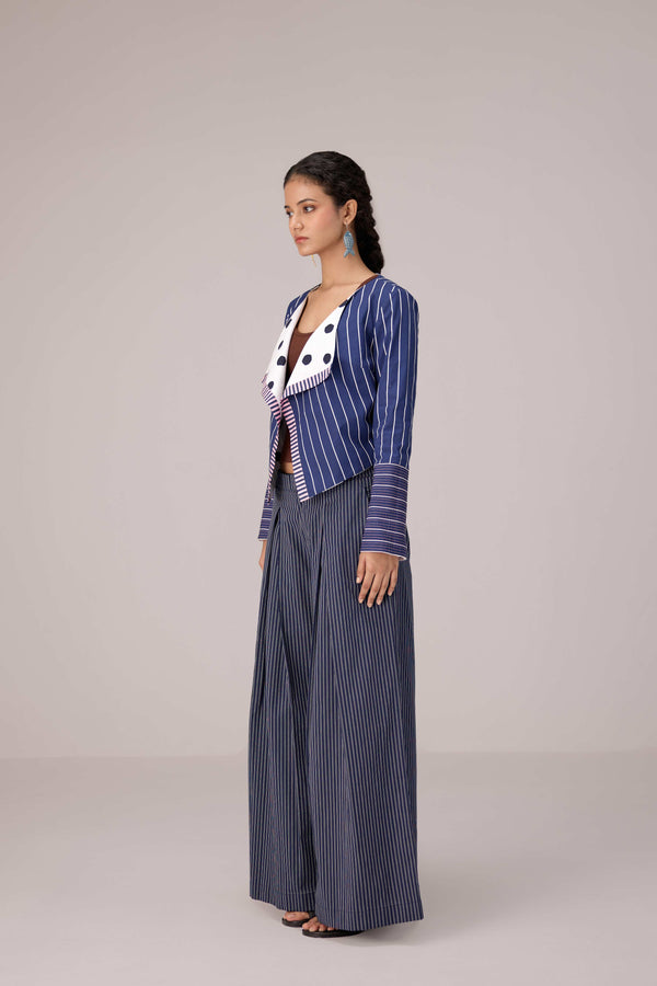 Reversable wrapped jacket in cotton linen paired with pleated striped pants in cotton