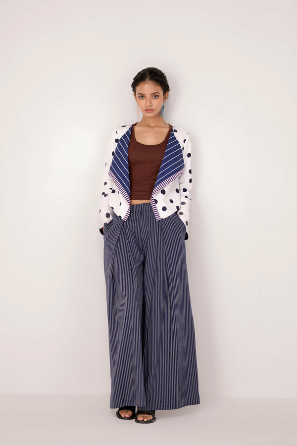 Reversable wrapped jacket in cotton linen paired with pleated striped pants in cotton