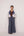 Reversable wrapped jacket in cotton linen paired with pleated striped pants in cotton