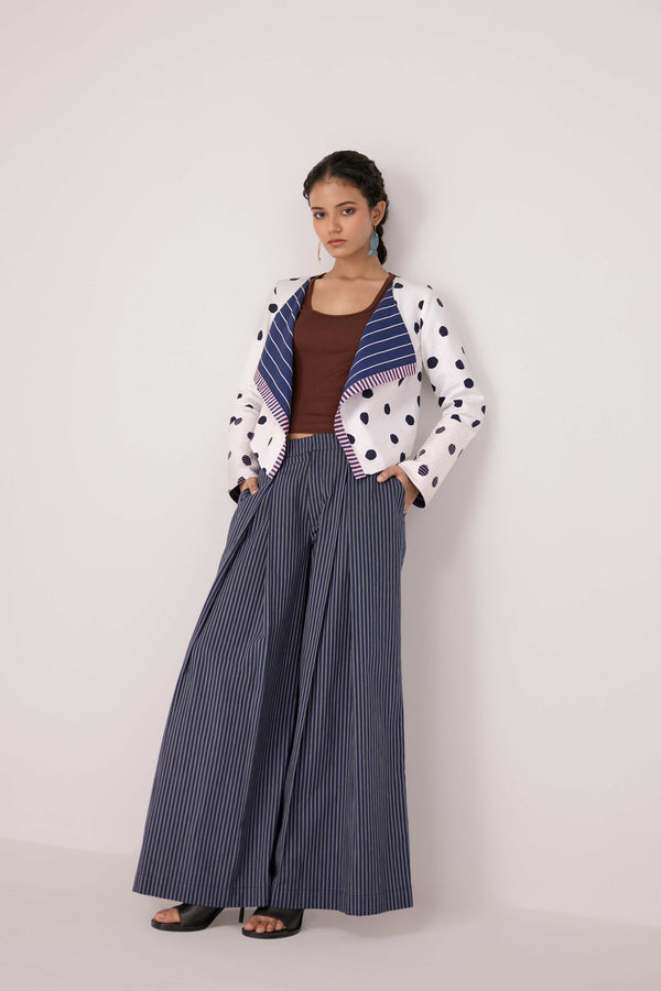 Reversable wrapped jacket in cotton linen paired with pleated striped pants in cotton