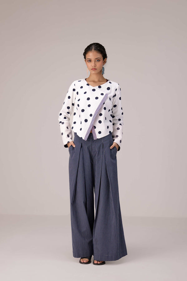 Reversable wrapped jacket in cotton linen paired with pleated striped pants in cotton