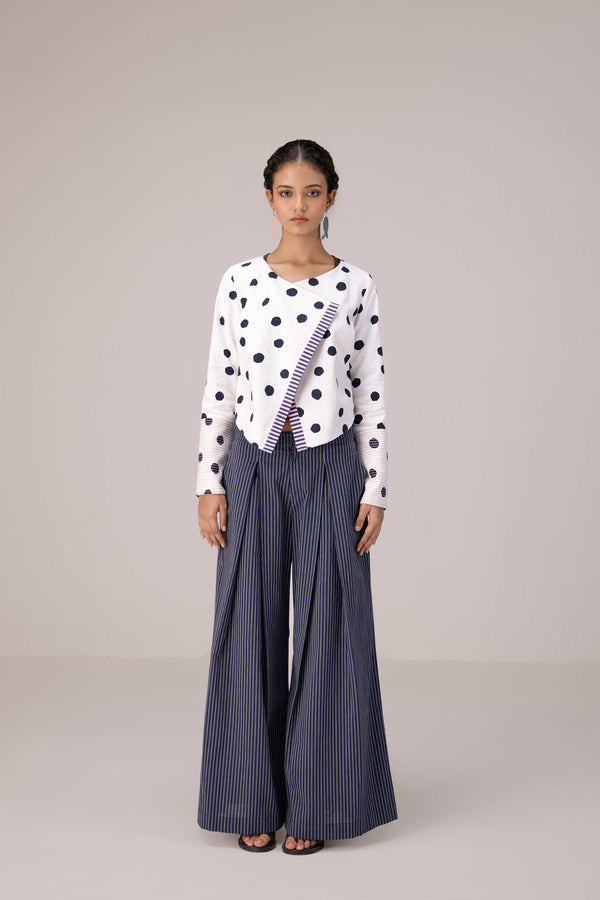 Reversable wrapped jacket in cotton linen paired with pleated striped pants in cotton