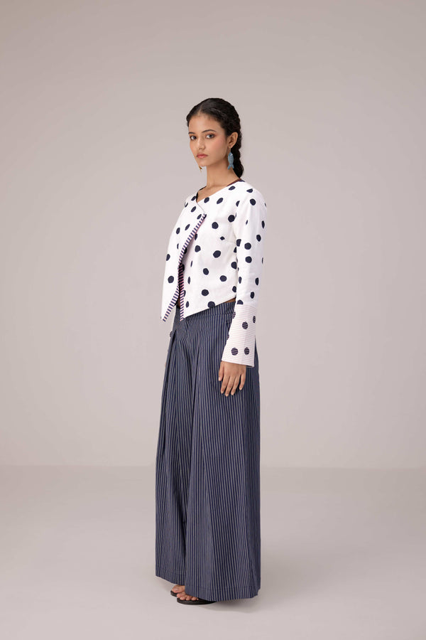 Reversable wrapped jacket in cotton linen paired with pleated striped pants in cotton