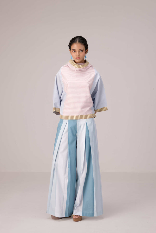 Oversized cotton top with pastel strips paired with wide legged pleated trousers