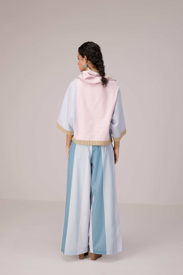 Oversized cotton top with pastel strips paired with wide legged pleated trousers