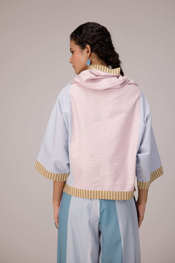 Oversized cotton top with pastel strips paired with wide legged pleated trousers