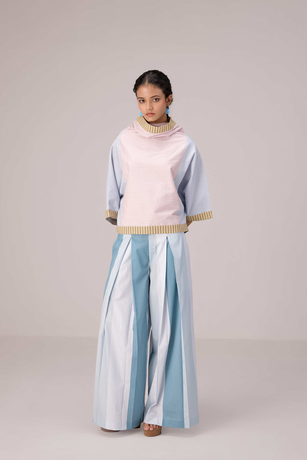 Oversized cotton top with pastel strips paired with wide legged pleated trousers