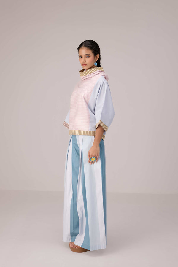 Oversized cotton top with pastel strips paired with wide legged pleated trousers