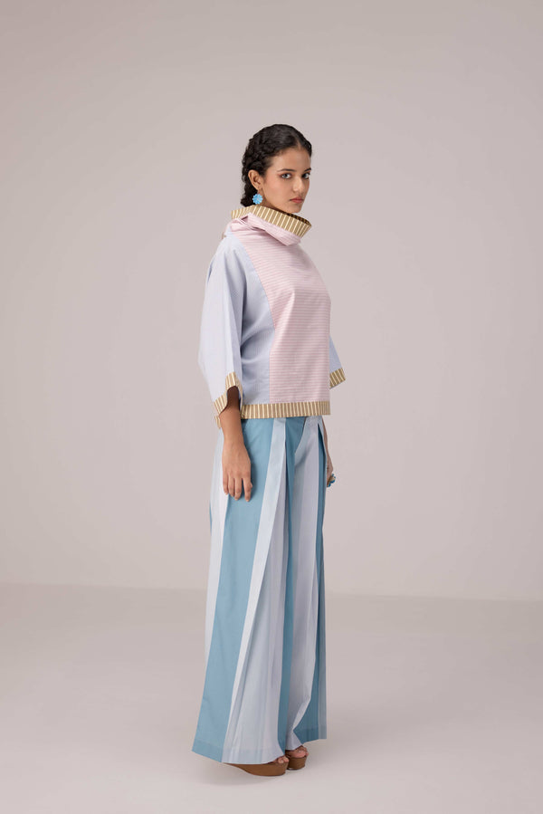 Oversized cotton top with pastel strips paired with wide legged pleated trousers