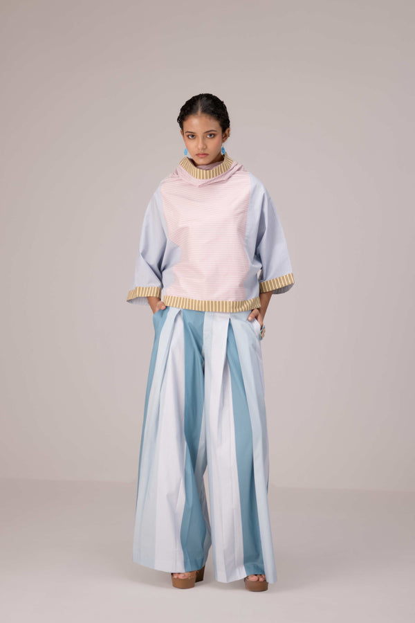 Oversized cotton top with pastel strips paired with wide legged pleated trousers