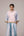 Oversized cotton top with pastel strips paired with wide legged pleated trousers