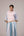 Oversized cotton top with pastel strips paired with wide legged pleated trousers
