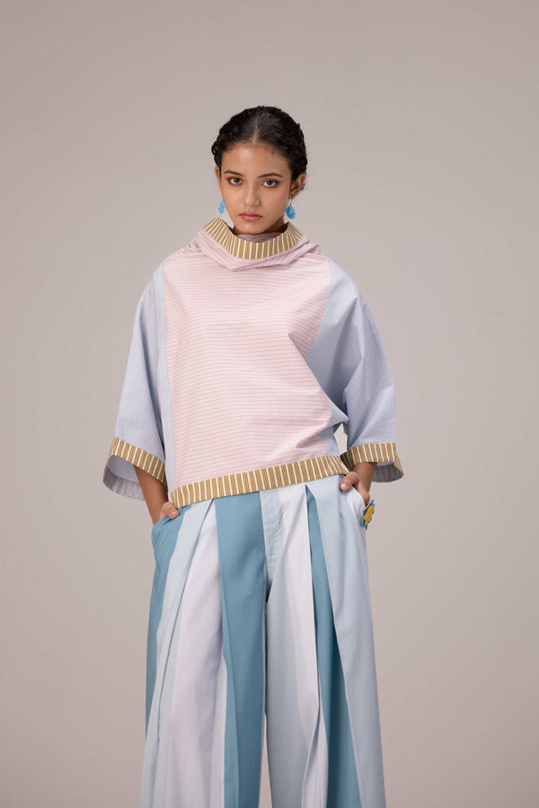 Oversized cotton top with pastel strips paired with wide legged pleated trousers