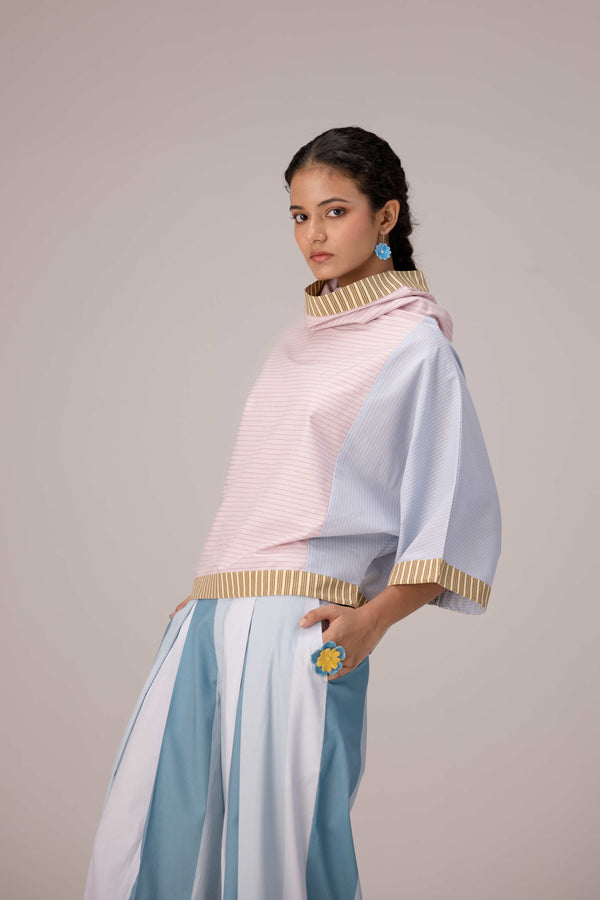 Oversized cotton top with pastel strips paired with wide legged pleated trousers
