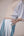 Oversized cotton top with pastel strips paired with wide legged pleated trousers