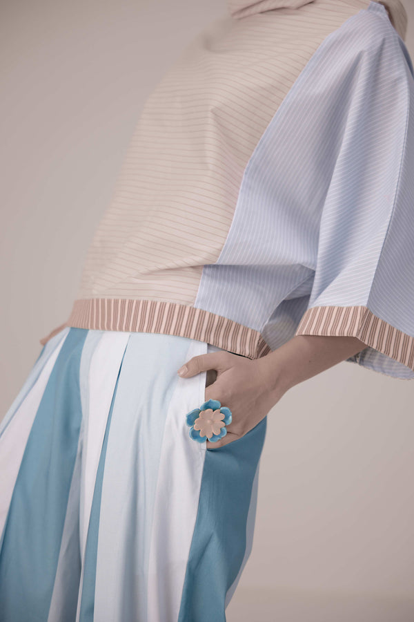 Oversized cotton top with pastel strips paired with wide legged pleated trousers