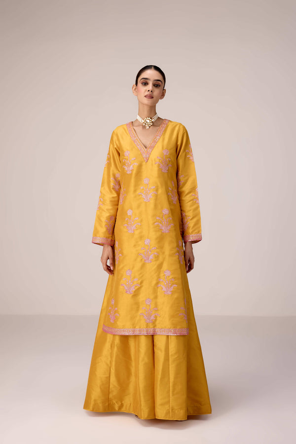 Mustard pink gold patch and thread embroidered kurta pants set.