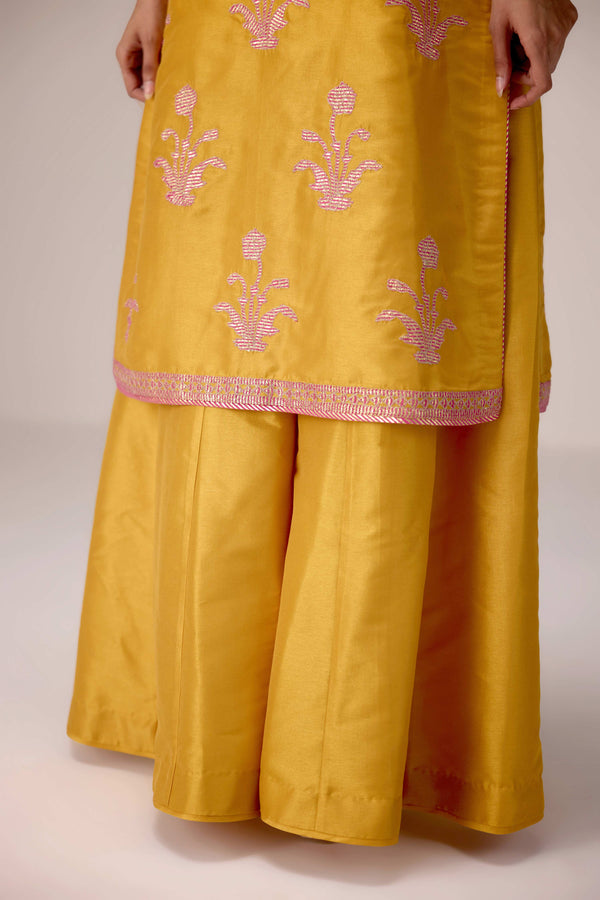 Mustard pink gold patch and thread embroidered kurta pants set.